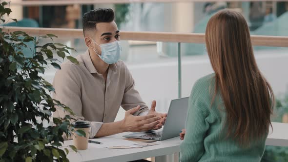 Arabic Boss Leader Hr Manager in Medical Mask Lead Interview with Female Candidate Shaking Hands for alt