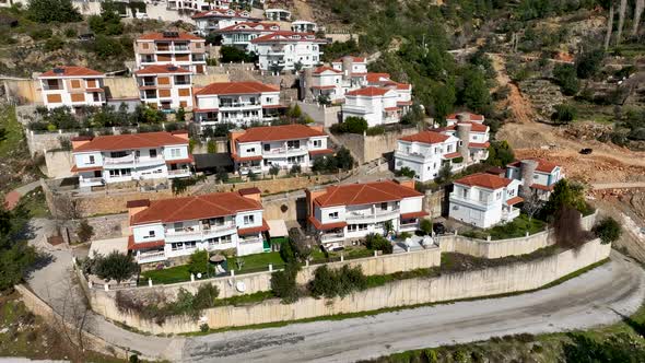 Complex of villas in the mountains aerial view 4 K alt