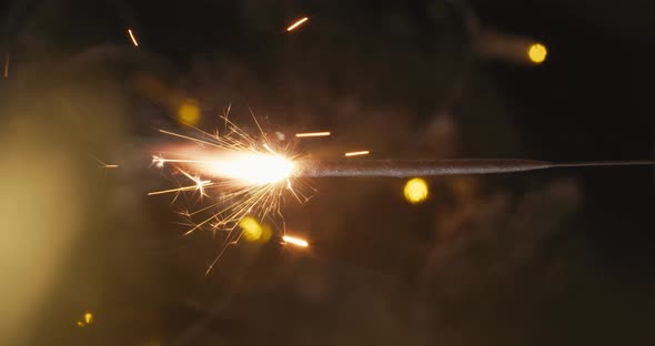 New Year's Sparkler in Tinsel on the Background of the Christmas Tree. Vertical Video alt