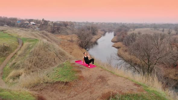 Young Woman Doing Yoga in Quiet Scenery