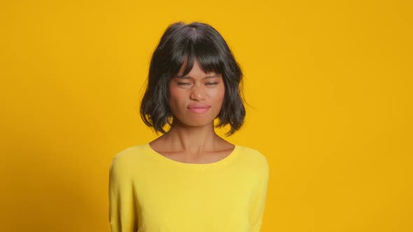 Displeased Dark Skinned Woman Looks with Aversion and Dissatisfaction Aside alt