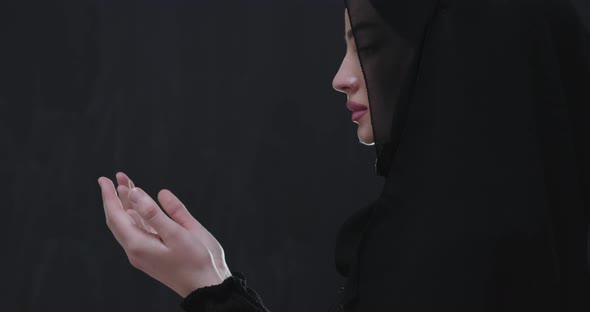 God Keeps Hands in Praying Gesture Isolated on Black Chalkboard Background alt