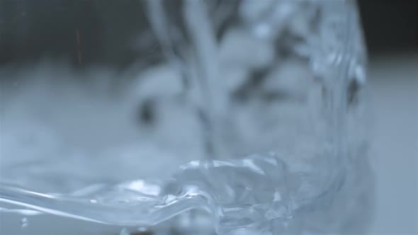 Water pouring in glass macro slowmotion