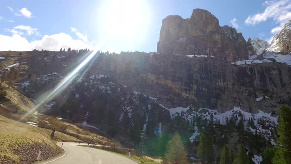 Speeding car on the winding roads in the Dolomites in early spring, Alps alt