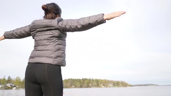 Healthy woman doing some exercise, woman doing exercise in the morning by the lake alt