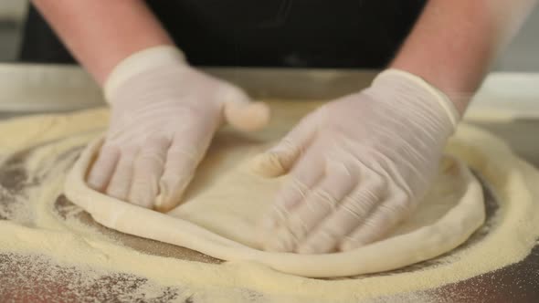 Chef Forming Dough for Pizza and Kneading It with Hands alt