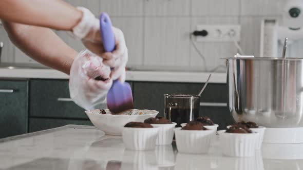 A Chef Making a Cake  Putting Cherry Filling in the Pastry Bag alt