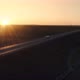 Police Car With Flashes Of Beacons Driving On The Highway At Sunset  - VideoHive Item for Sale