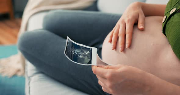 Shot From Above with View of Pregnant Girl Sitting Comfortably on Sofa Wearing Sweatpants and alt