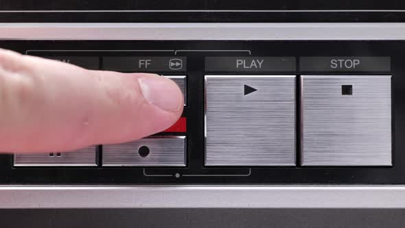 Extreme close up of buttons on an old antique or vintage VCR Pushing Fast forward alt