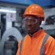 African American Engineer Looking Camera in Industrial Manufacturing Factory - VideoHive Item for Sale