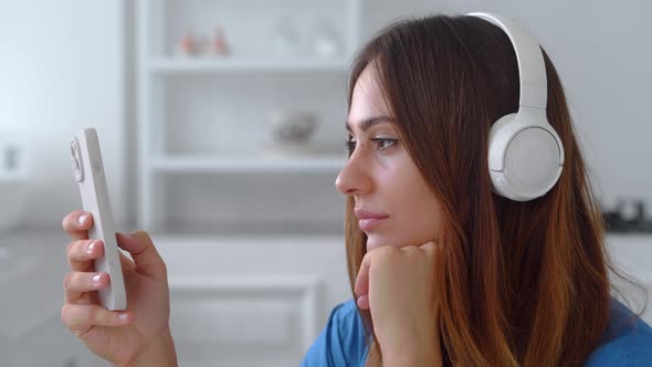 Girl is Thinking What to Write in an Answer to a Friend on a Smartphone App alt