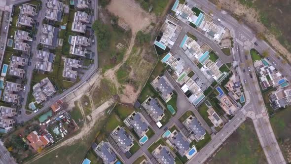 Drone descent into for sale plot of land surrounded by premium chalets alt