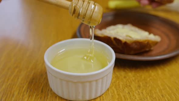 Commercial Footage a Young Girl Cuts Bread with a Knife Spreads a Sandwich with Butter and Pours alt