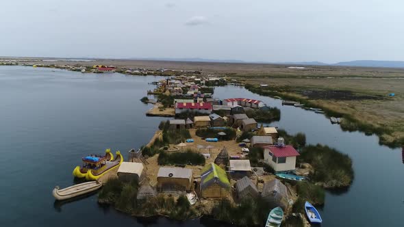 Slow drone movement. Uros Floating Islands over Titicaca lake, Peru alt