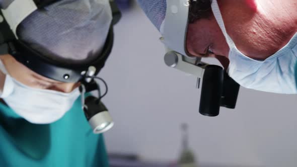 Surgeons performing operation in operation room alt