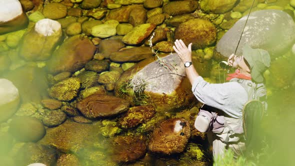 Fisherman fly fishing in river alt