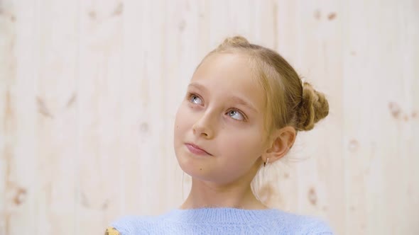 Portrait Thoughtful Teenager Girl on a Light Background in Studio alt