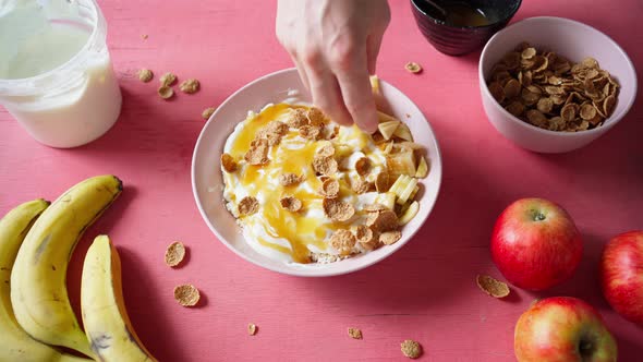 Adding Flakes to Salad From Cottage Cheese Yogurt Fruits and Honey alt