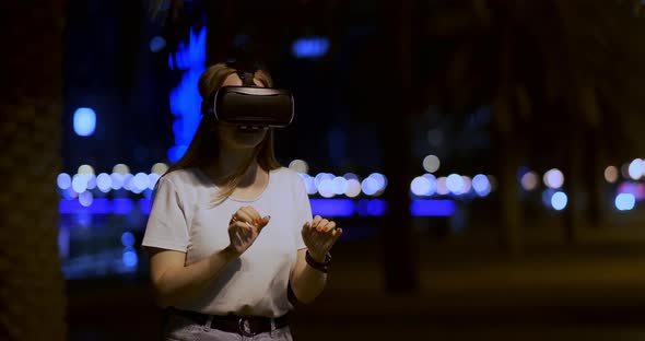 Young Girl in Virtual Reality Glasses in a Big Metropolis alt