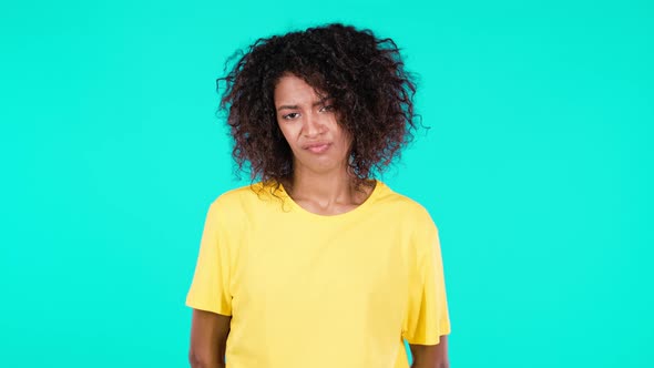 Irritated African Woman Sighs Rolling Eyes on Teal Background alt