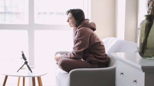 Cheerful Girl Video Blogger Recording Vlog Looking Talking to Camera alt