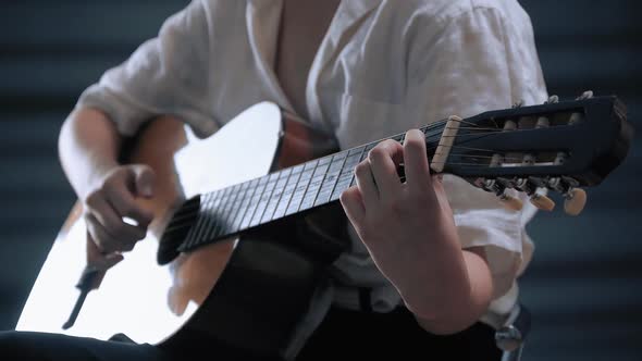 Girl Playing Guitar at Studio