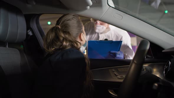 Video of medical worker performing drive-thru COVID-19 test. Shot with RED helium camera in 8K. alt