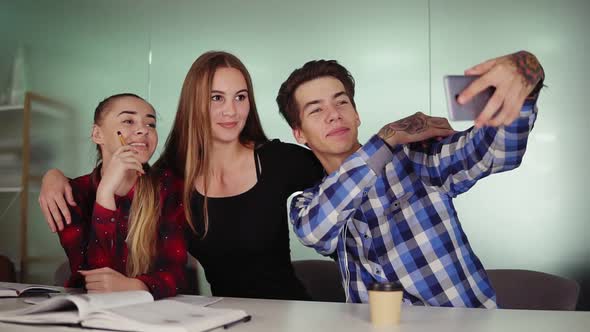 Smiling Business People Taking Selfie in a Meeting Room at Creative Sitting at the Table and alt