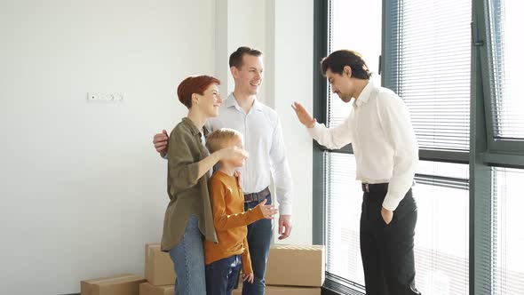 Happy Young Man Taking Bunch of Keys By Real Estate Agent to Own Flat After Making Successful