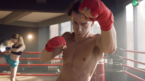 Male Boxer Hitting in the Air on the Camera in the gym alt