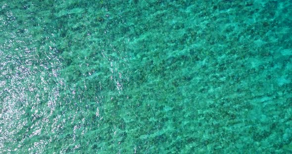 Beautiful above travel shot of a sunshine white sandy paradise beach and aqua blue ocean background  alt