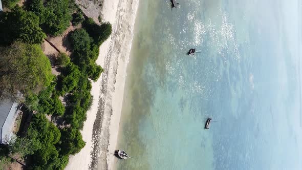 Vertical Video Boats in the Ocean Near the Coast of Zanzibar Tanzania Aerial View alt