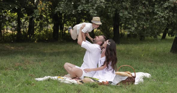 Father and Mother Reaching for Their Male Child