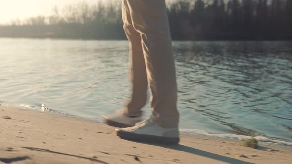 Businessman Walks And Enjoying Good Weather At Fall. Man Feet Walking On Beach. Legs Walking On Sand alt