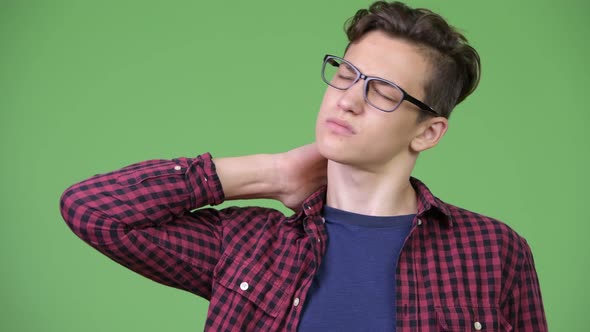 Young Handsome Teenage Nerd Boy Having Neck Pain alt