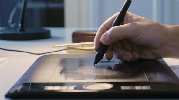 Man Drawing with Digital Pen on Graphic Tablet
