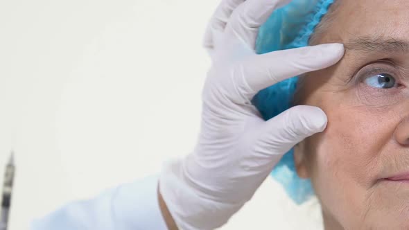 Female Beautician Hand Injecting Hyaluronic Acid, Facial Rejuvenation Procedure alt