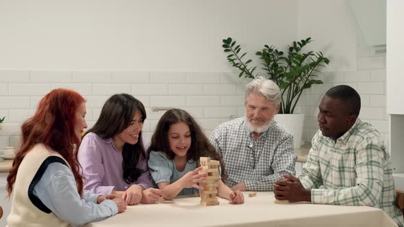 Cheerful Multi Ethnic Family of Different Age Generations Playing Board Game at Home alt