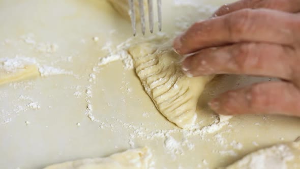 Woman Prepares Dough For Cooking With A Fork