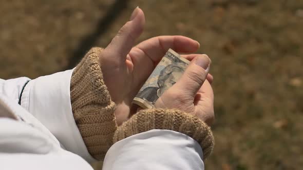 Mature Female Holding Dollar Hand, Retirement Poverty, Social Insecurity, Budget