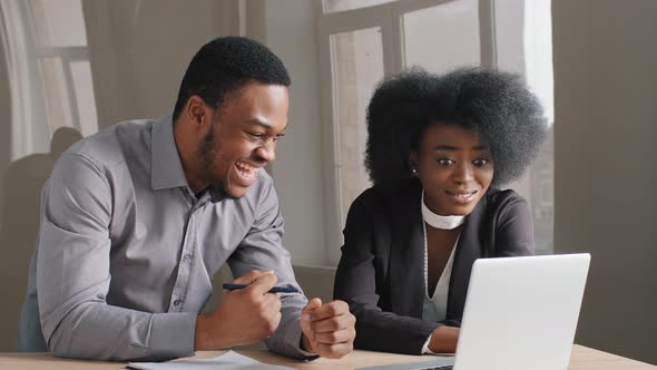Young African American Office Workers Guy and Girl Work Successfully Together with Concentration alt