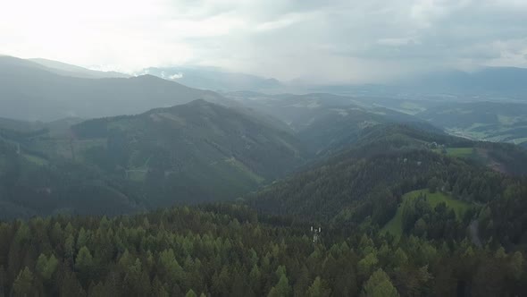 Camera Is Flying Over Amazing Pine Forest on Mountain, Through Clouds, Moving Back