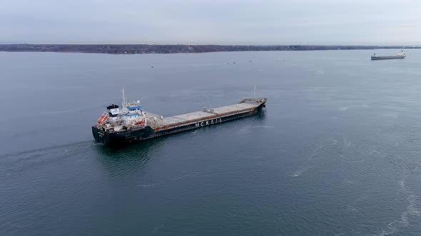 4K aerial footage of a cargo ship crossing the Beauharnois Canal in the St Lawrence Seaway, Canada.