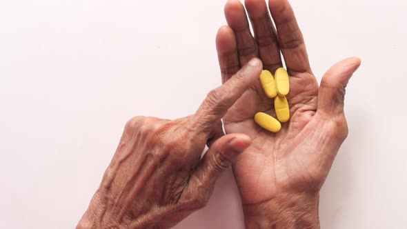  Senior Women Hand's Taking Medicine, Close Up  alt