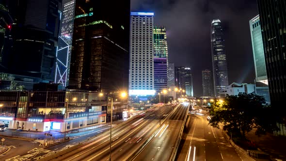 No Visible Brand Names or Logos. Hong Kong Rush Hour Traffic at Night. Time Lapse of Skyscraper alt