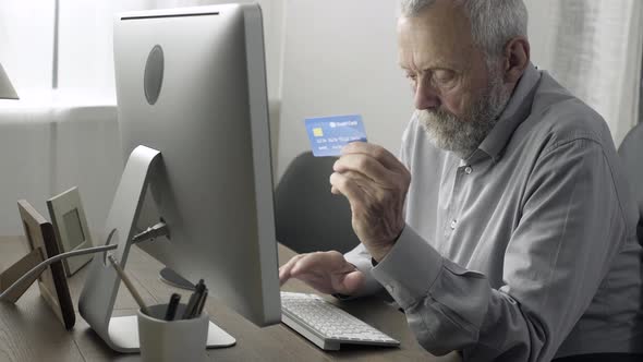 Senior man doing shopping online with his credit card