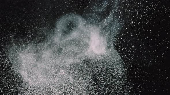 White Particles on a Black Background. Wave of Small Round Dust. Close Up. Slow Motion alt