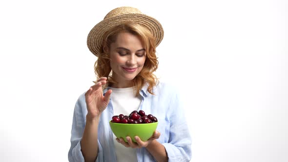 Smiling Woman Farmer in Straw Summer Hat Eating Fresh Cherry From Bowl Vitamin alt
