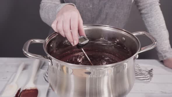 Step by step. Mixing ingredients in the cooking pot to make simple chocolate fudge. alt
